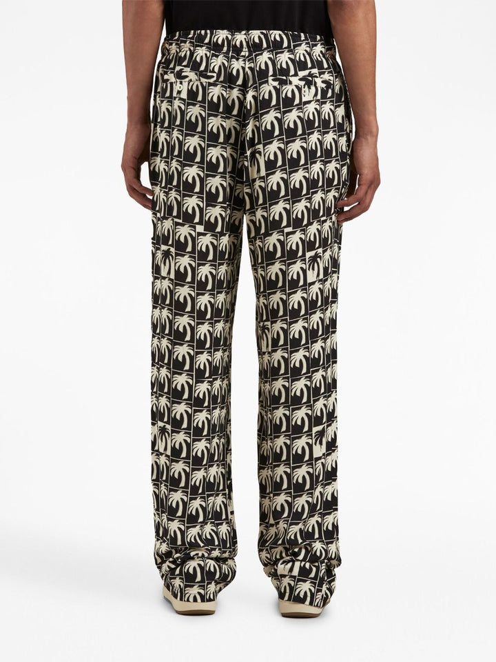 Palm Angels Pantalon ample à imprimé palmier - Lothaire