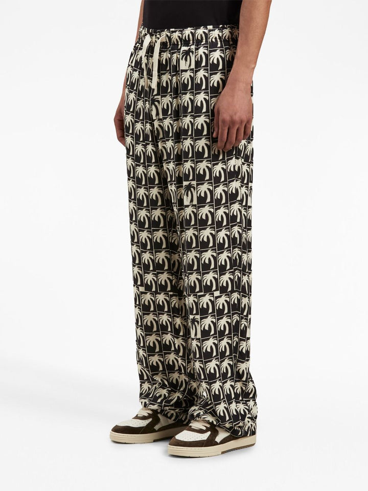 Palm Angels Pantalon ample à imprimé palmier - Lothaire